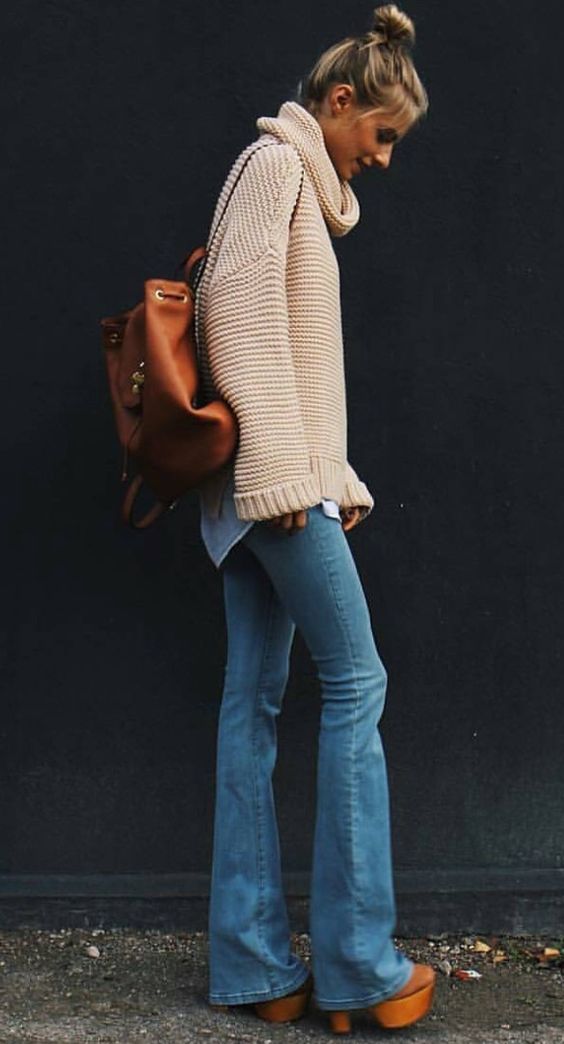 Chunky sweater with flared jeans and wooden heels