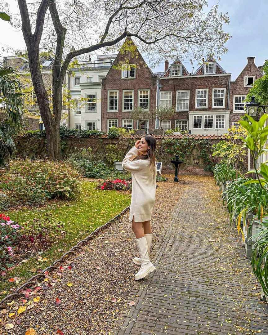 White knit dress with boots in garden