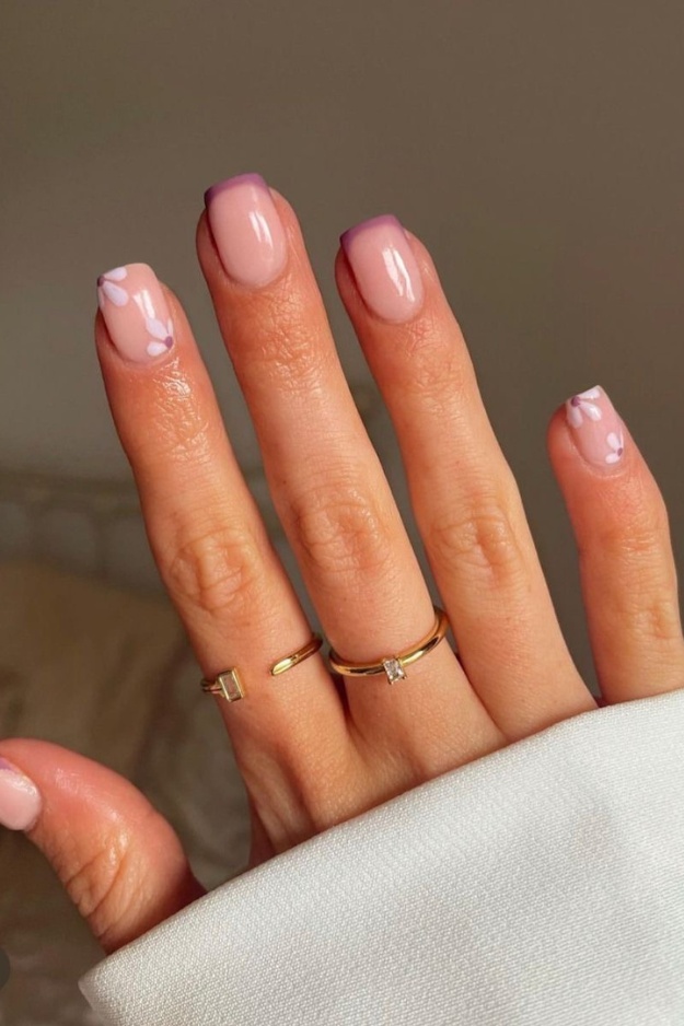 Pink square nails with a modern French twist and floral accents, perfect for playful and chic looks.