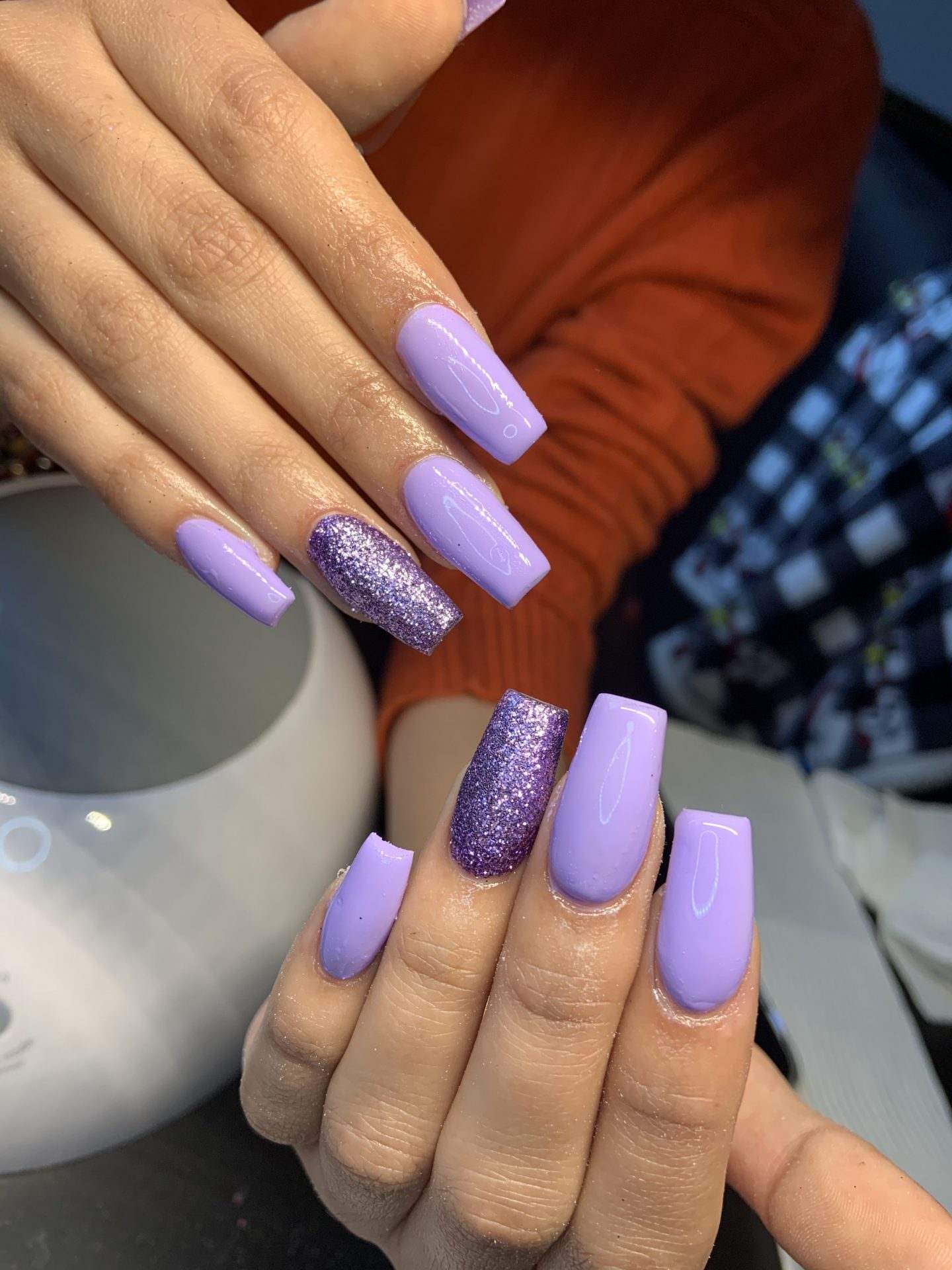 Lavender square nails with glitter accents, suitable for fun and festive looks.