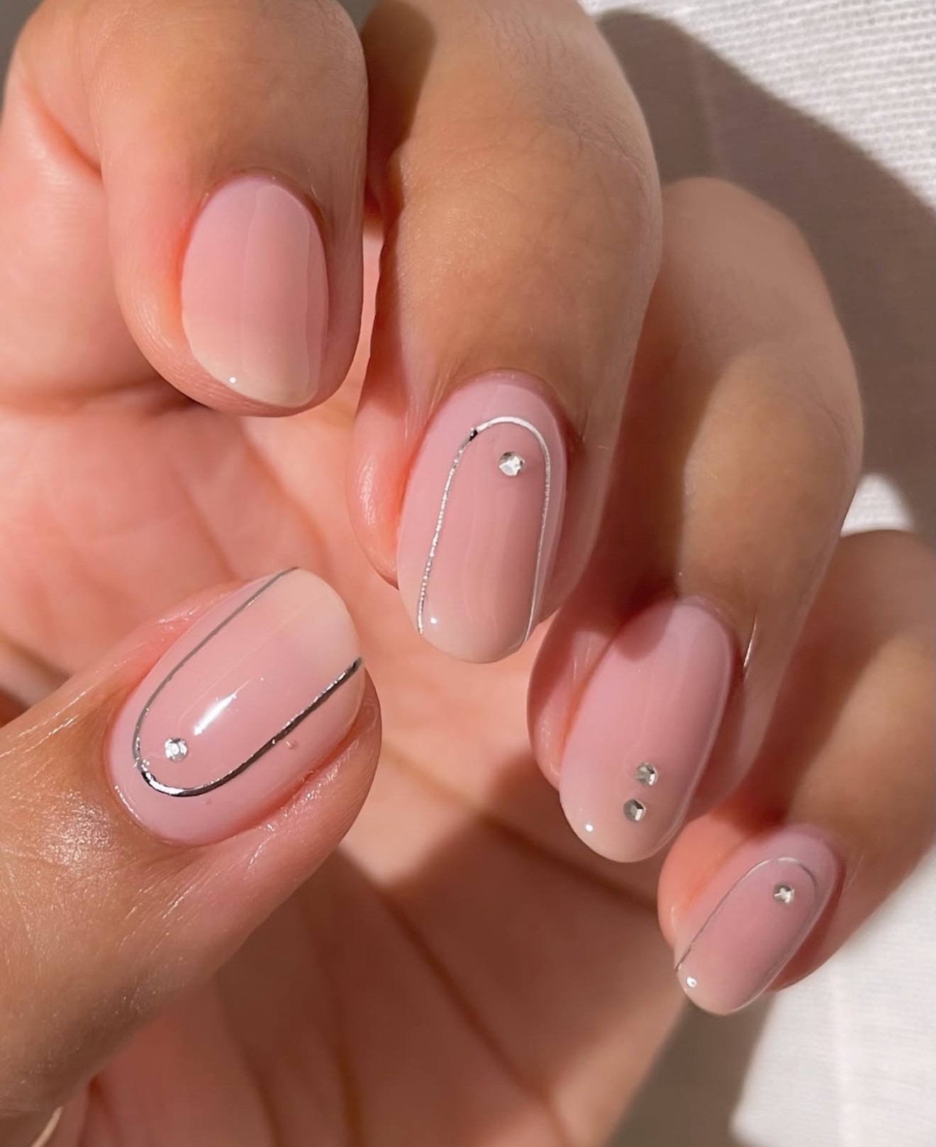 Silver lined nail art on square nails, perfect for modern and chic styles.