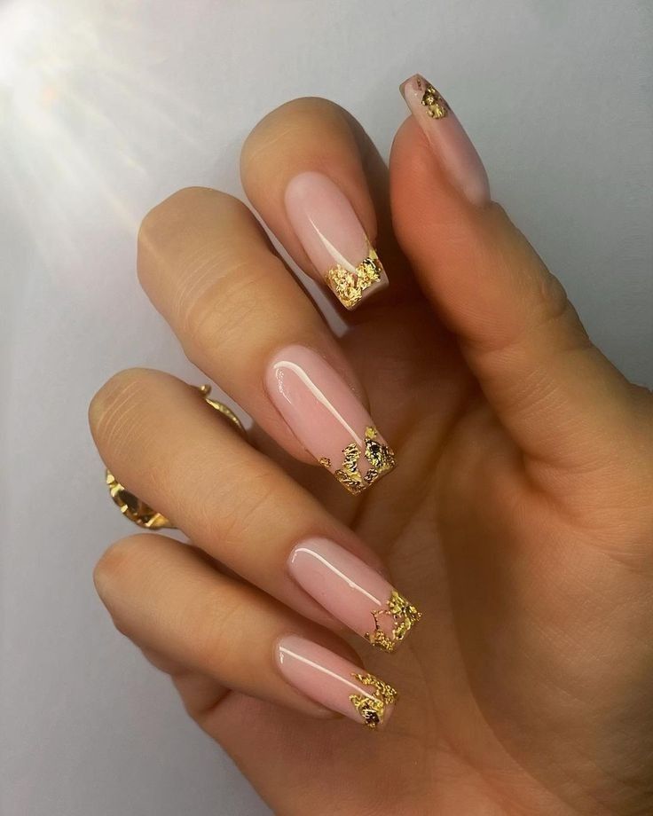 Pink nails with gold leaf tips, perfect for luxurious and chic styles.