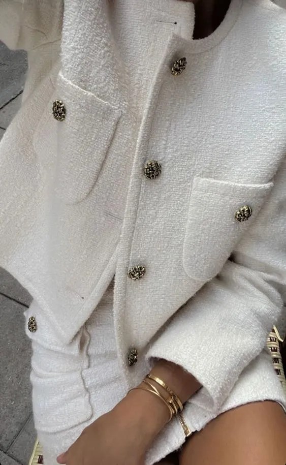 White tweed blazer with gold buttons and matching skirt