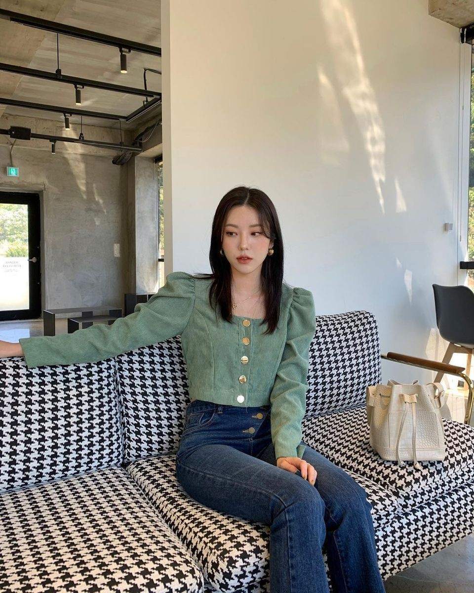 Green top with blue jeans