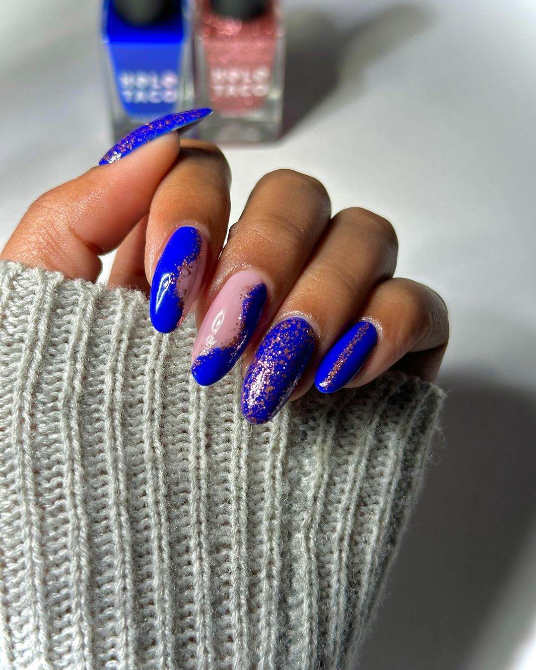 Electric blue glitter nails with a bold and dramatic flair