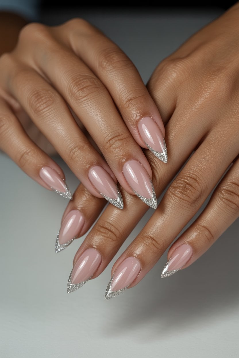 Sharp silver glitter stiletto nails with edgy elegance