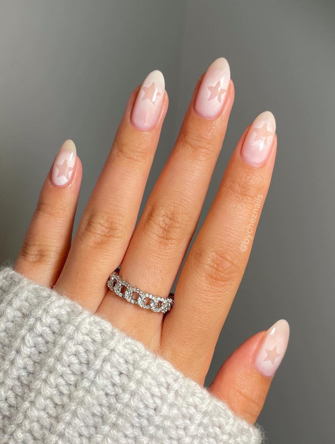 Starry soft pink almond nails with dreamy stars