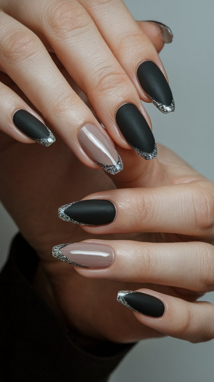 Matte black nails with silver glitter tips for an elegant contrast