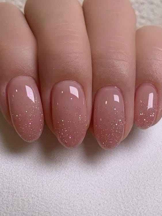 Dusty pink glitter ombre nails with a soft gradient