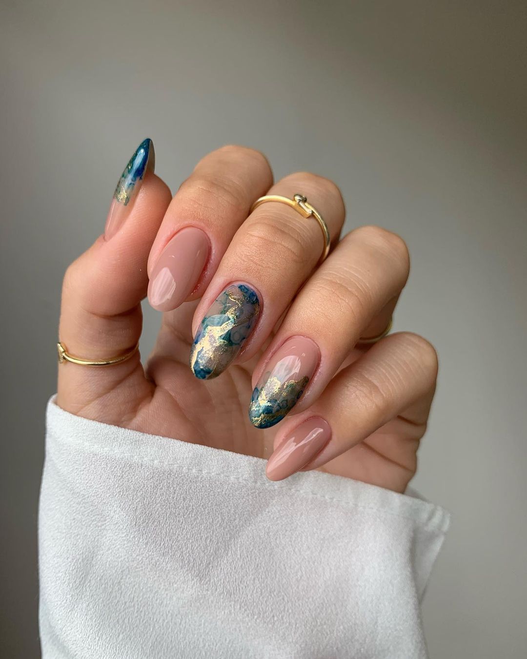 Navy marble almond nails with artistic flair