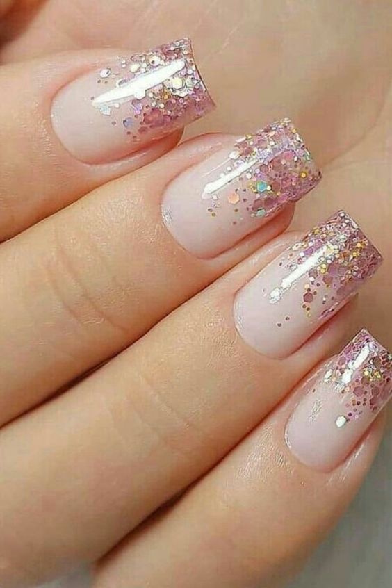 Pink glitter tip nails with a feminine touch