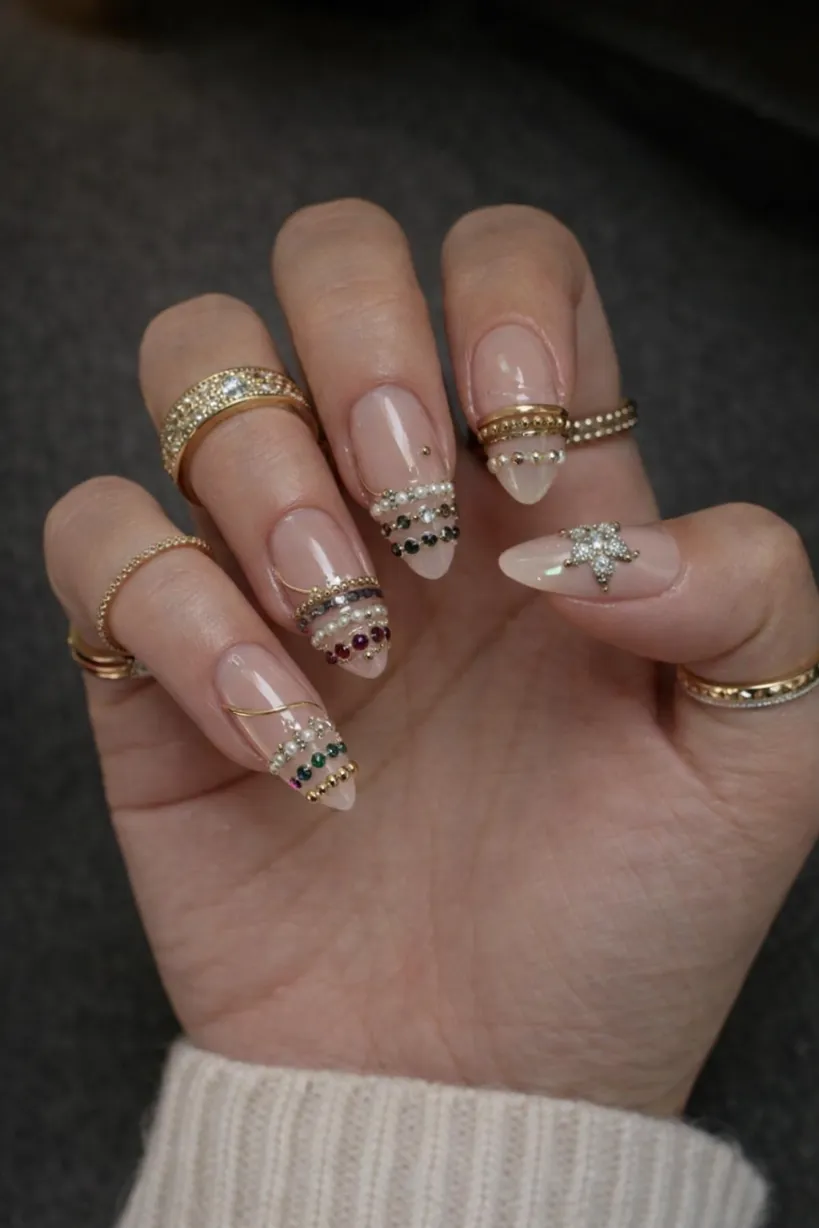 Gem-accented nails with nude base and long length