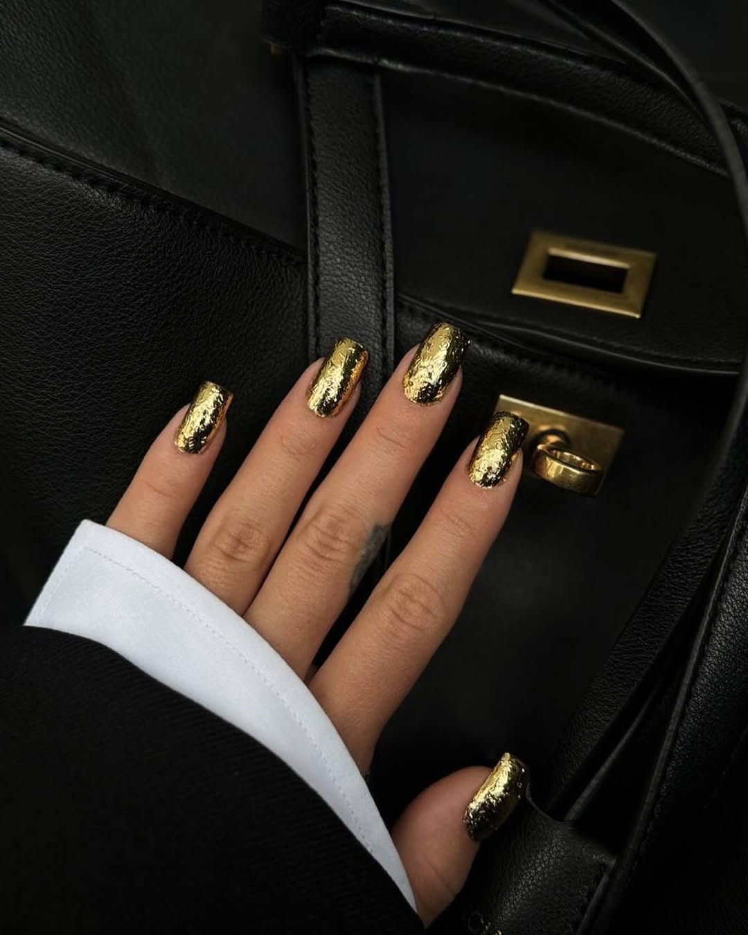 Black nails with cracked gold foil accents