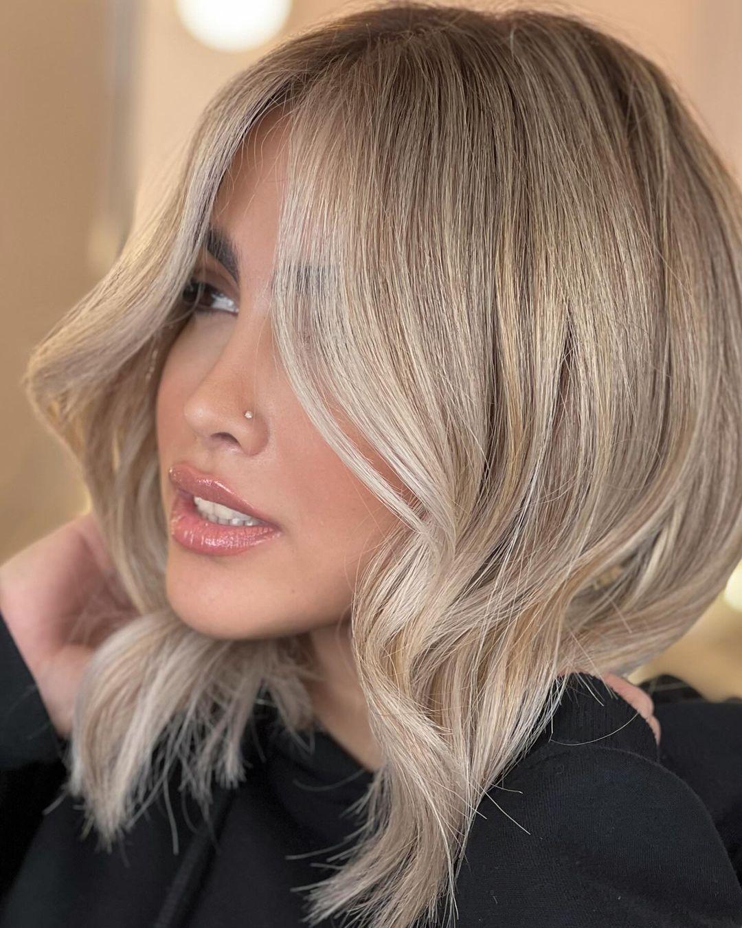 Soft wavy blonde bob with face-framing layers