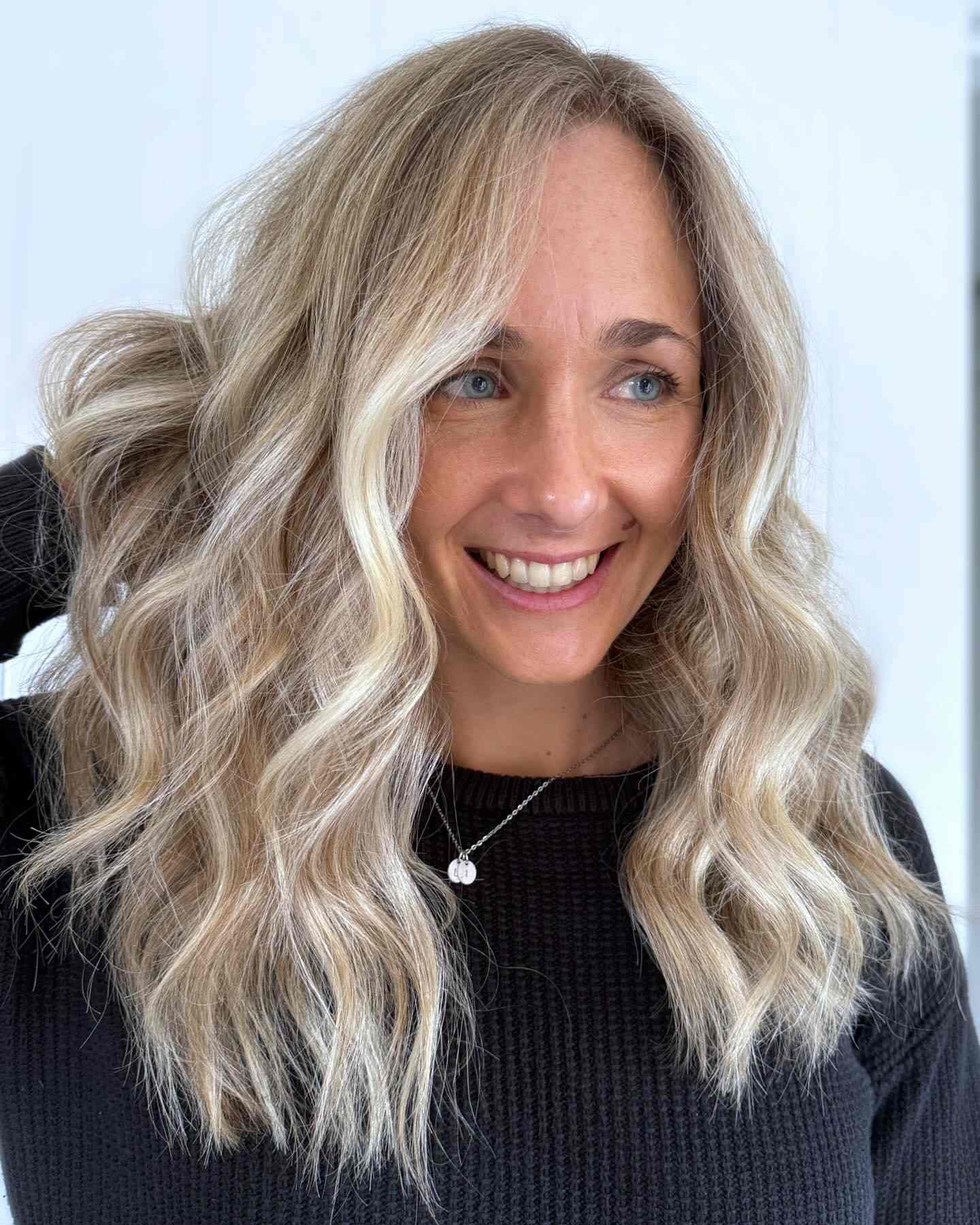 Golden blonde curls with face-framing highlights