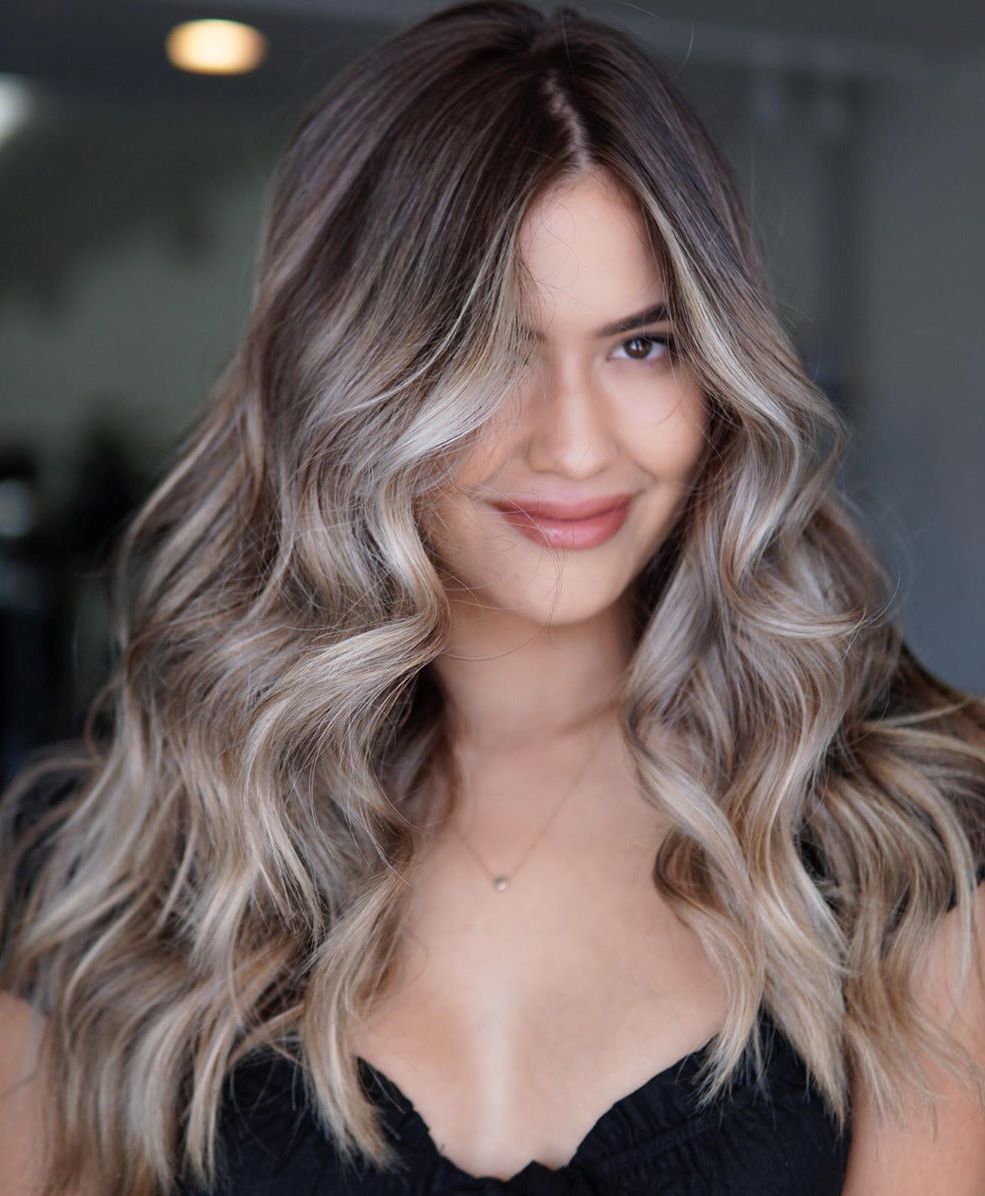 Long silver ash waves with dark roots