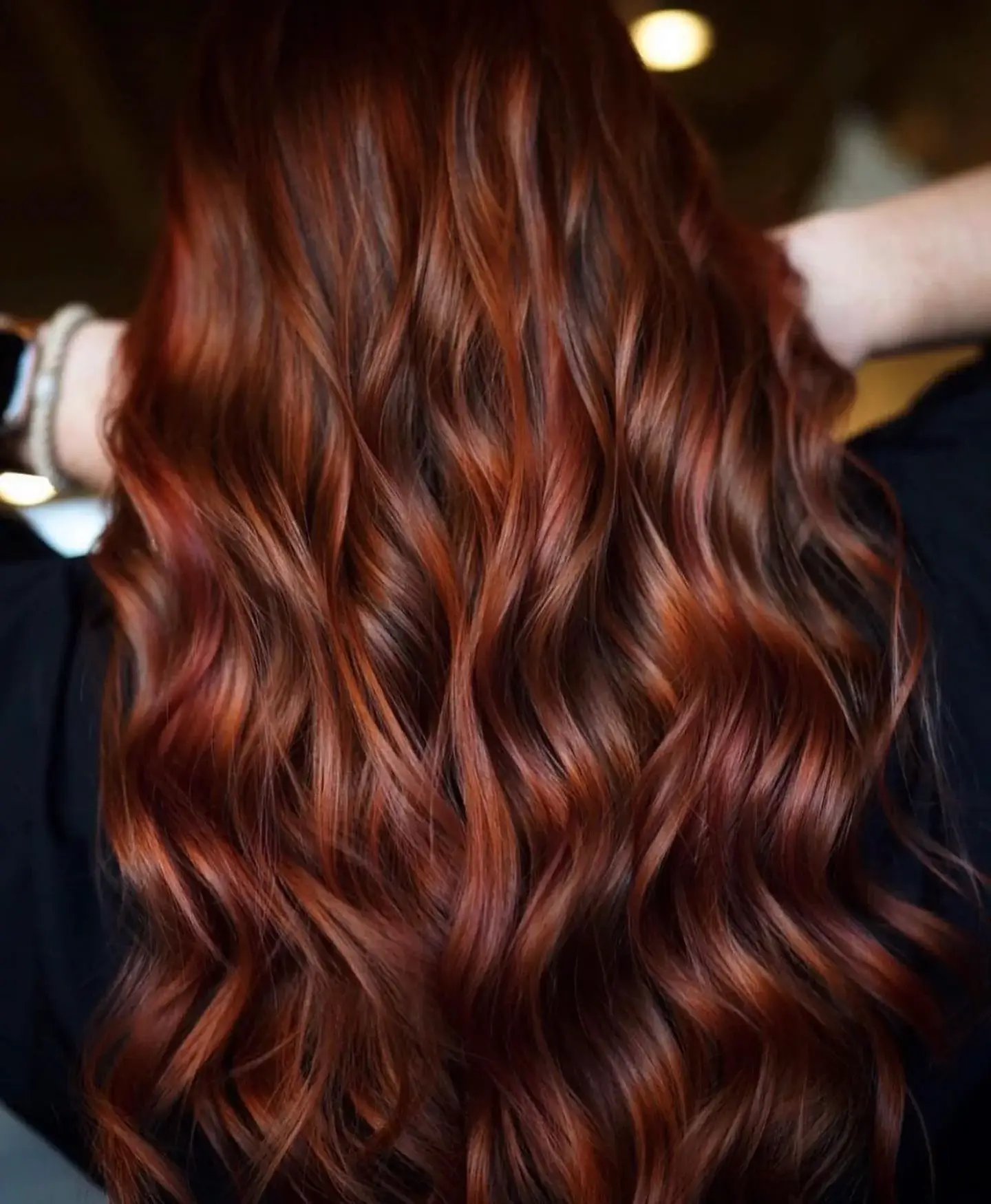Long deep auburn hair with soft waves