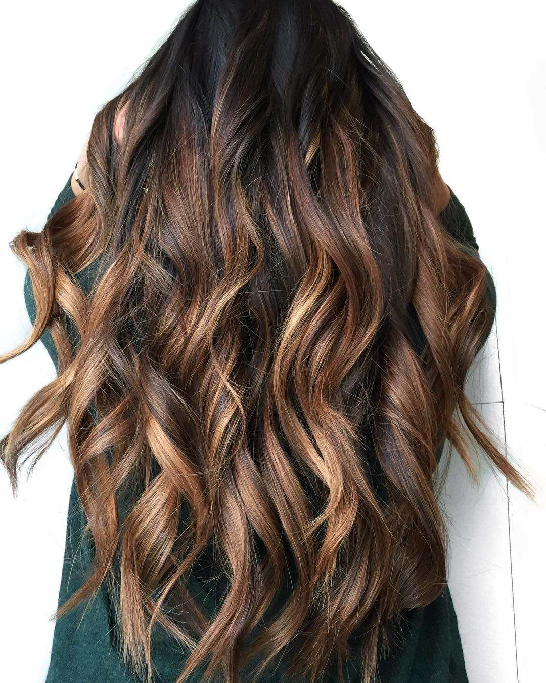 Long chestnut waves with caramel highlights