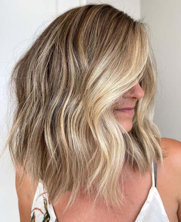 Soft waves with bright blonde balayage for a fresh look