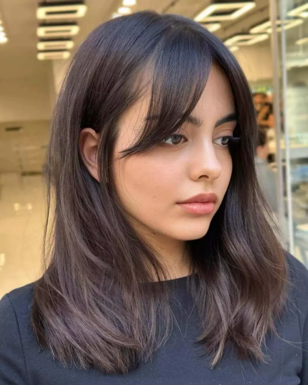 Textured lob with curtain bangs for a trendy vibe