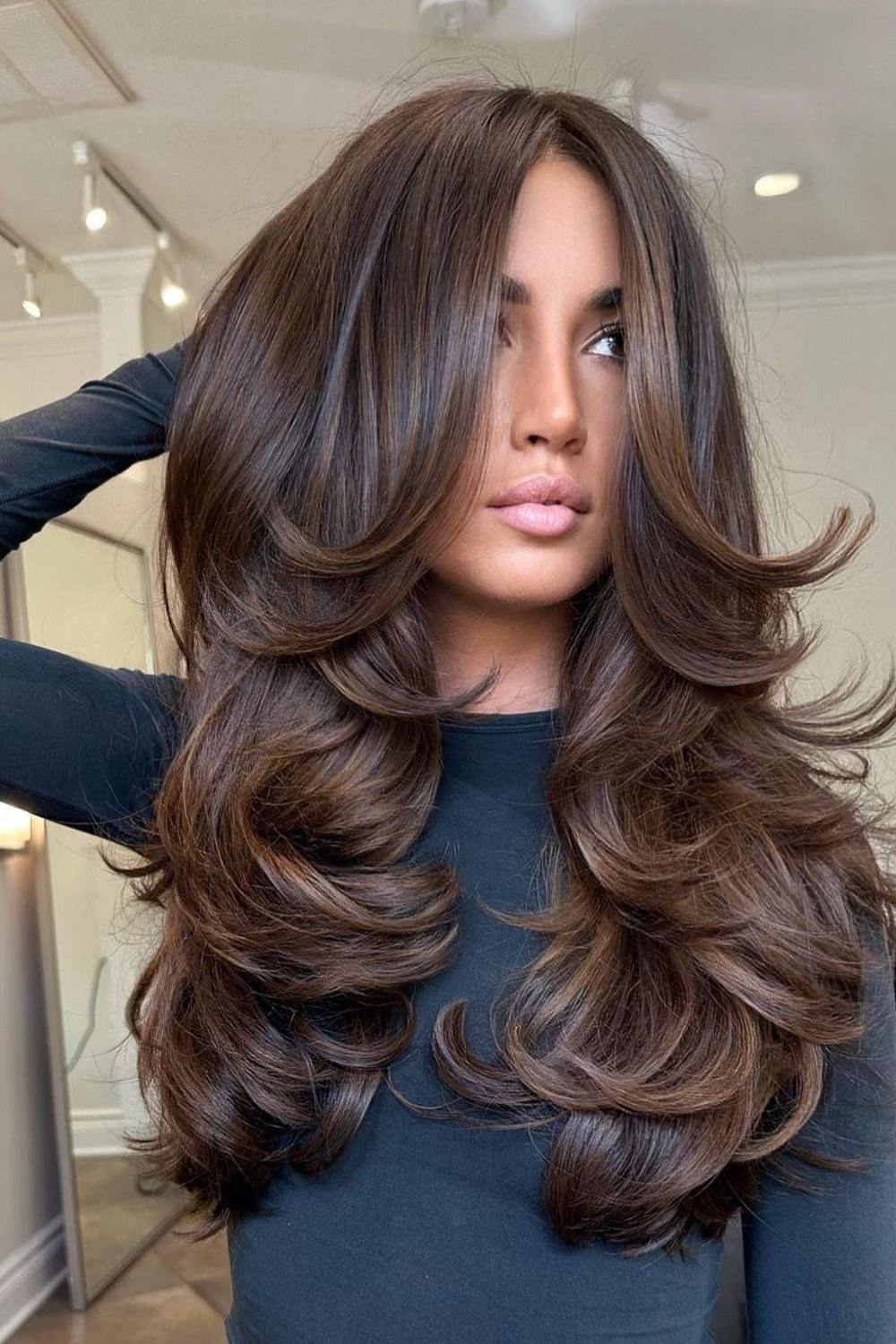 Long layers with luxurious curls for a glamorous look