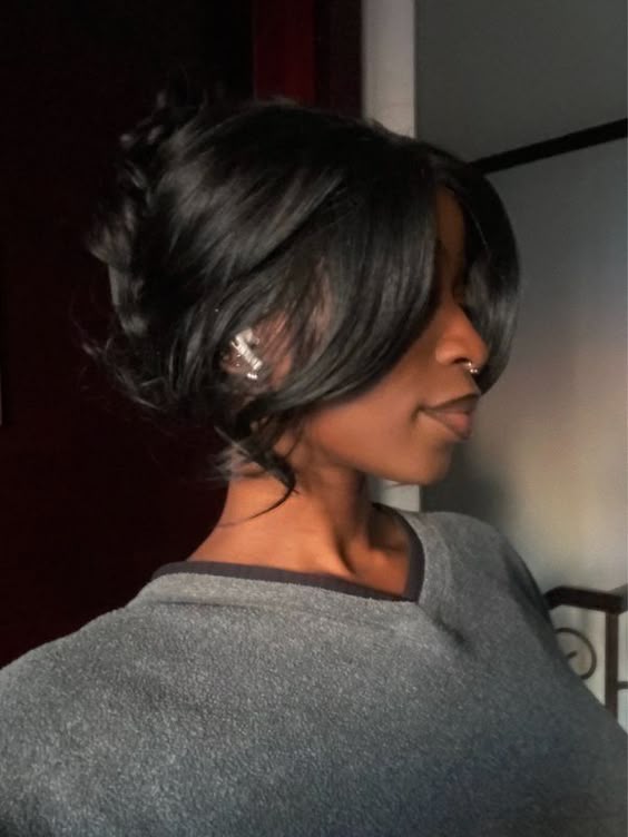 Sophisticated side-swept updo with loose tendrils