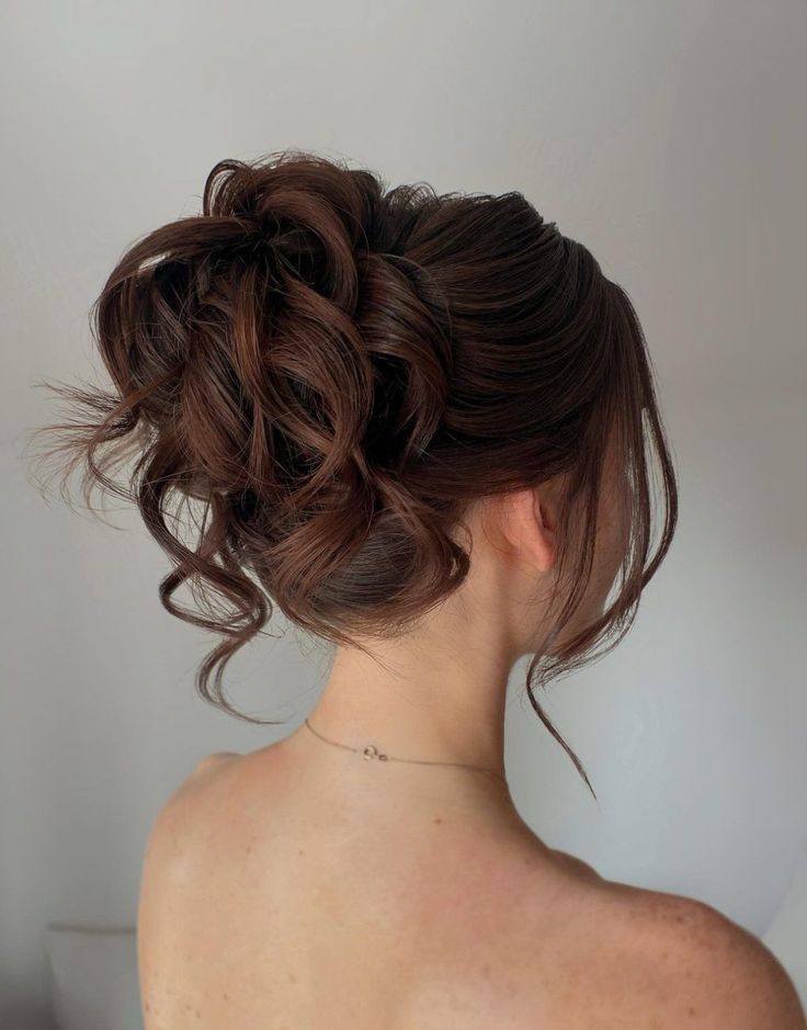 Textured updo with loose curls and volume