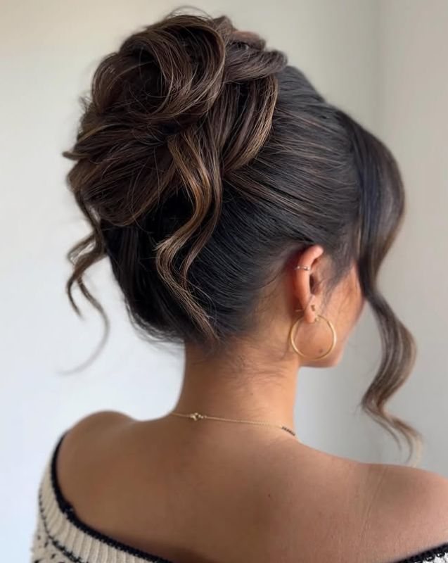 Sophisticated twisted bun with loose tendrils