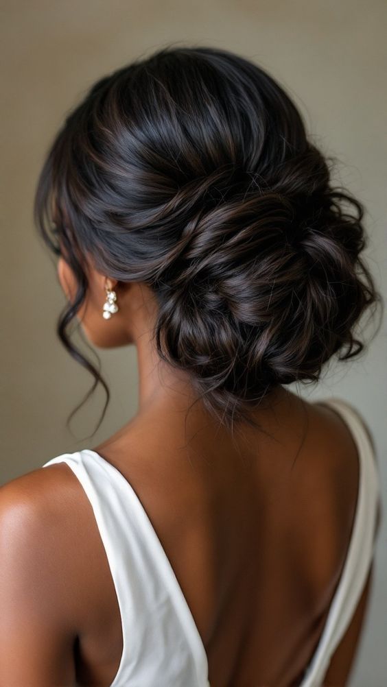 Elegant low bun with textured finish and dark hair