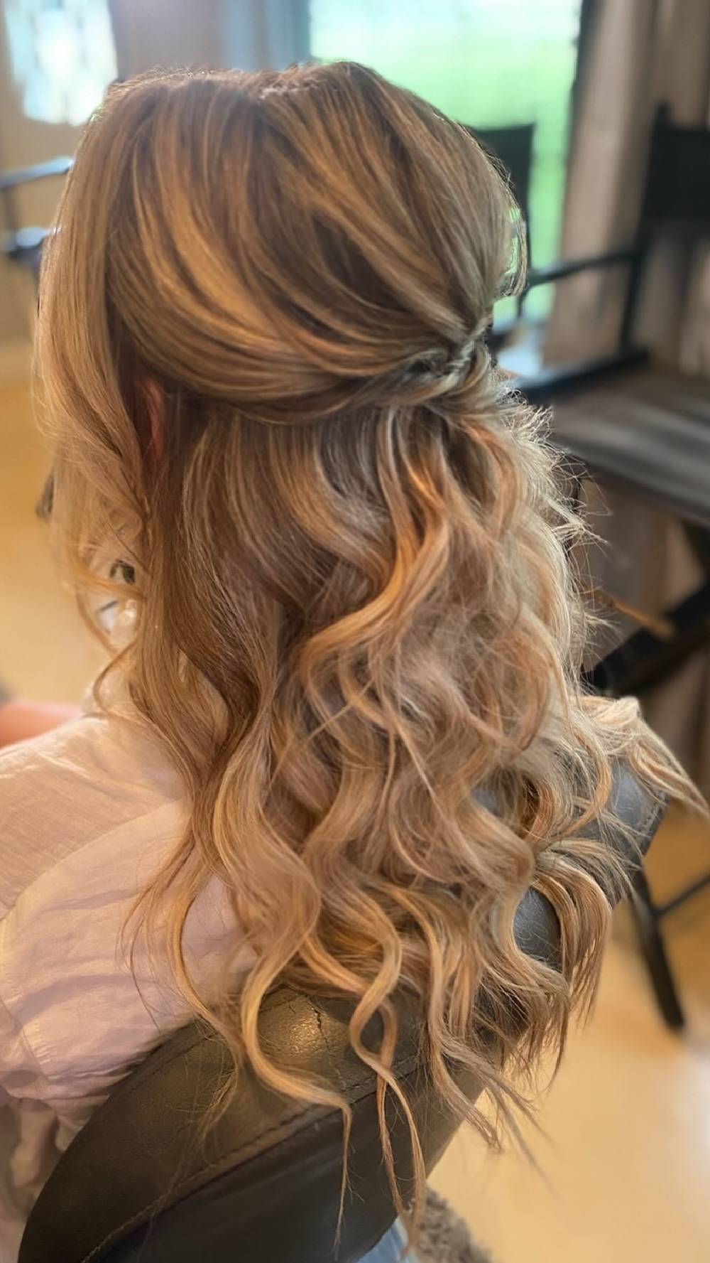 Beachy waves with half-up knot in highlighted hair
