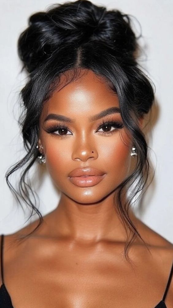 Elegant high bun with soft tendrils