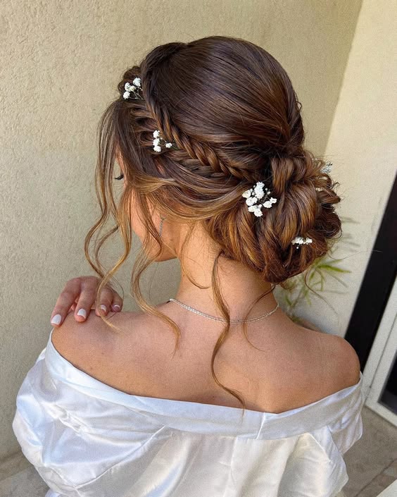 Romantic braided updo with florals and loose curls