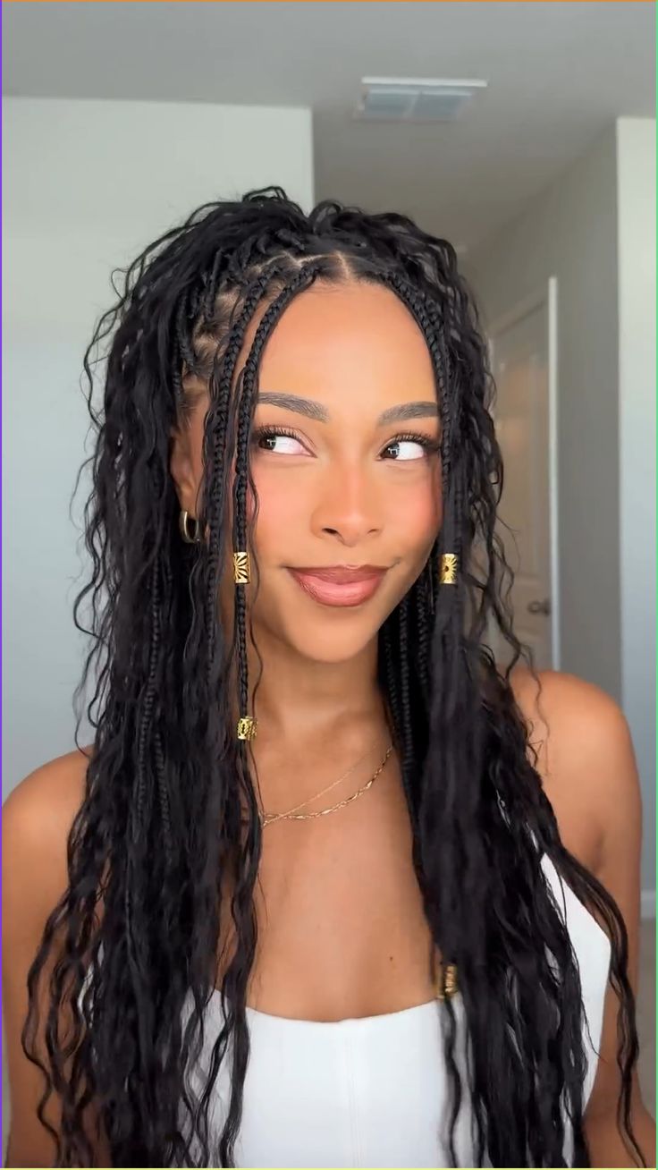 Intricate box braids with curls and gold accents
