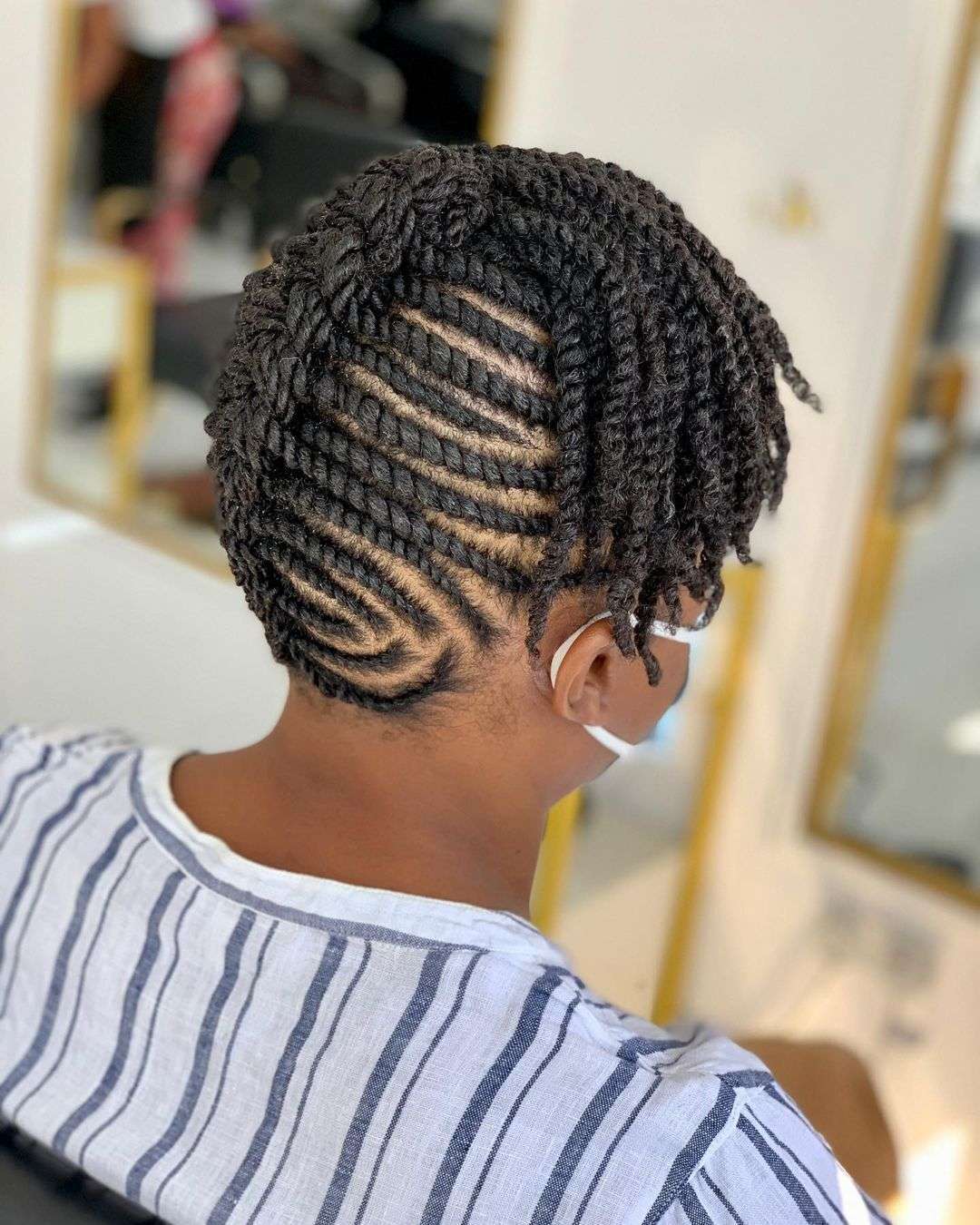 Intricate cornrow updo with side detail