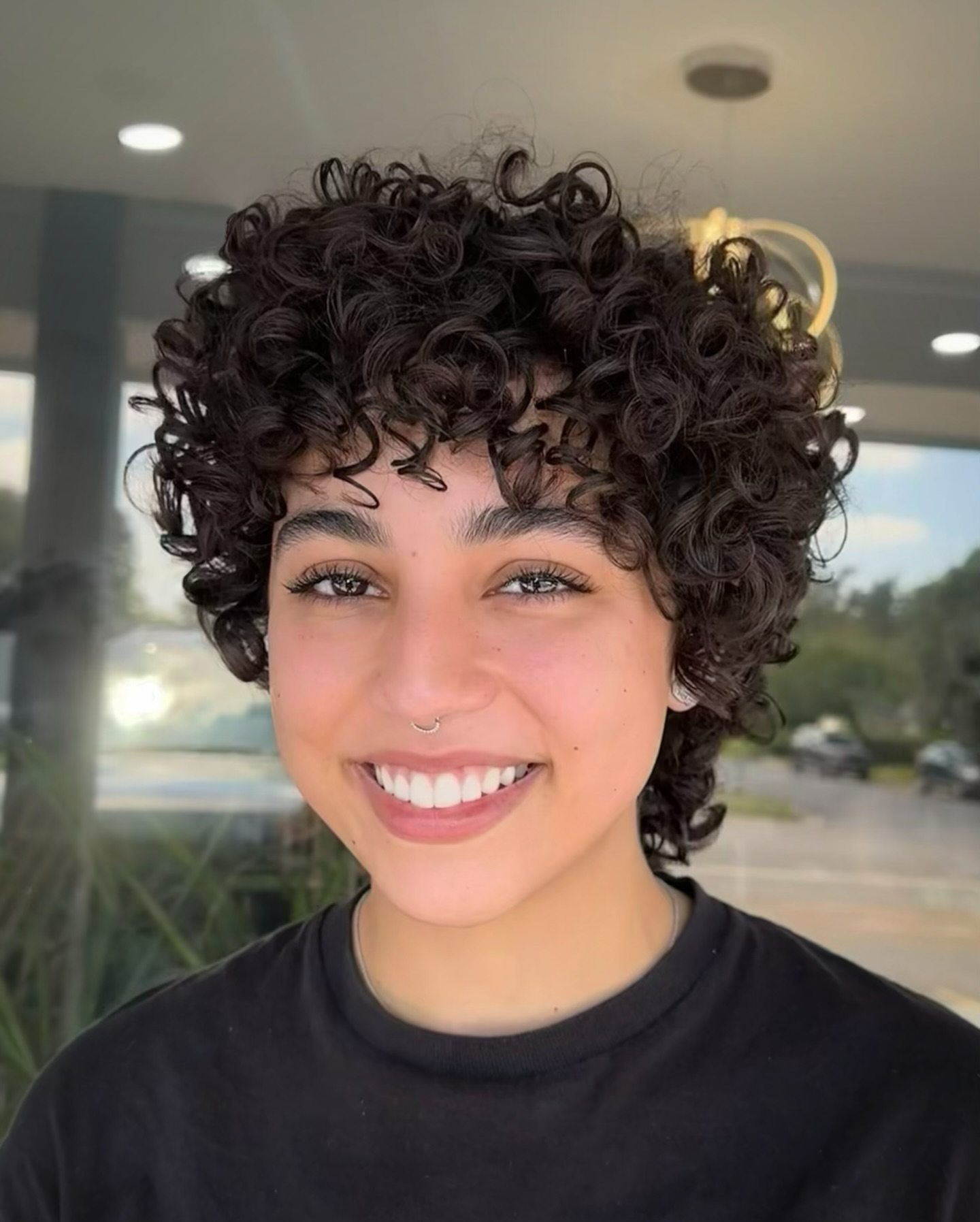 Voluminous curly pixie cut for bold look