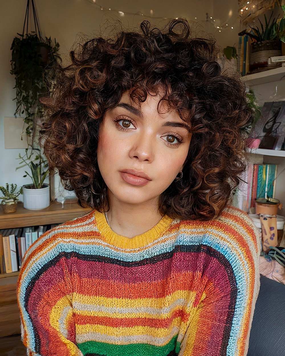 Classic curly bob with bangs for a playful look