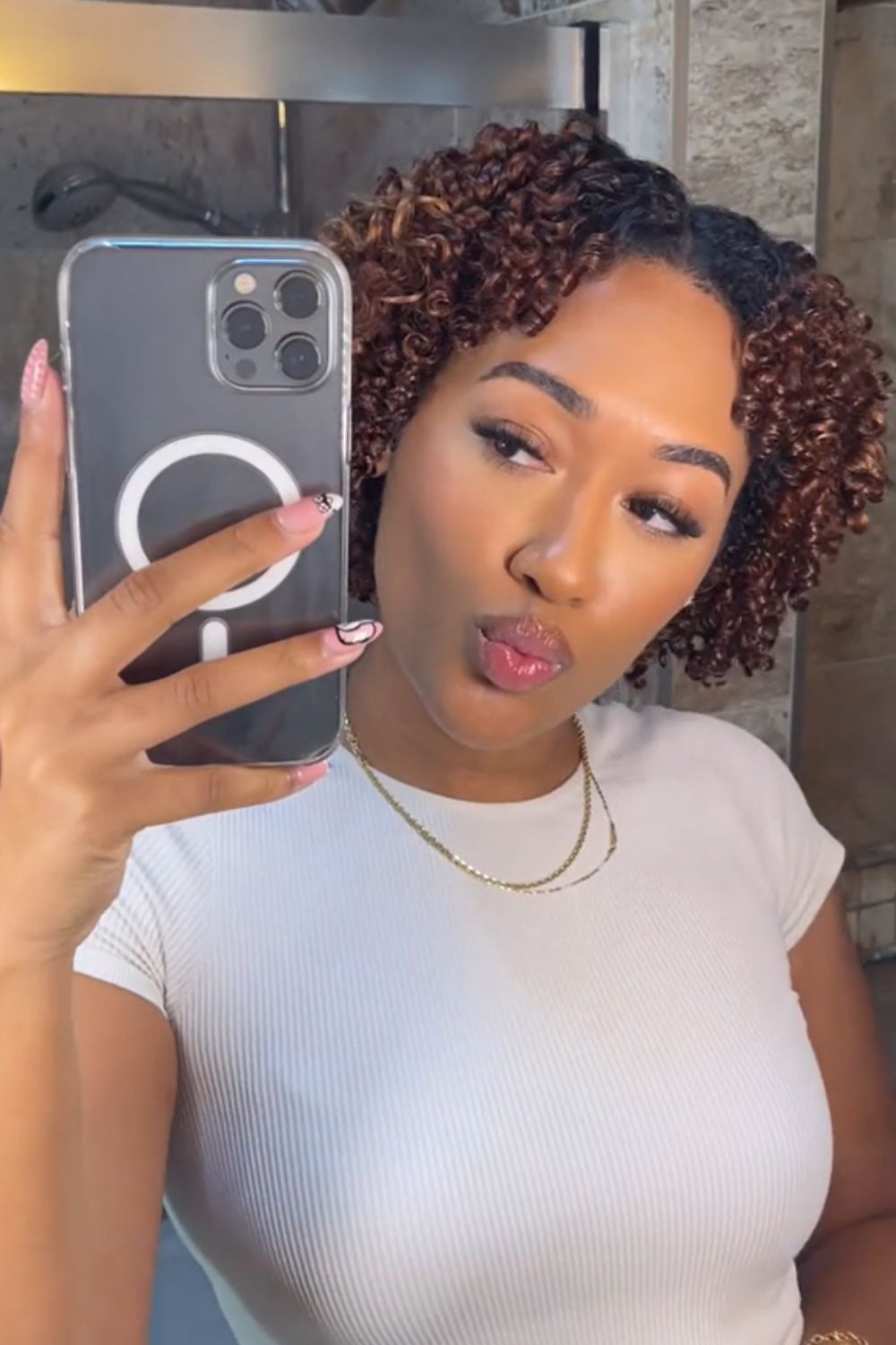 Defined curls with auburn highlights