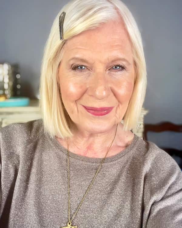 Blunt bob with side part and clip for older women
