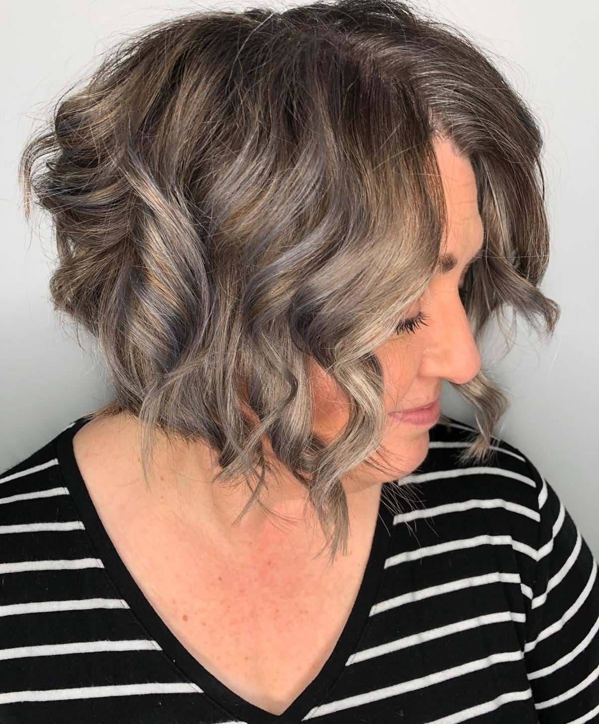 Curly bob with highlights for older women