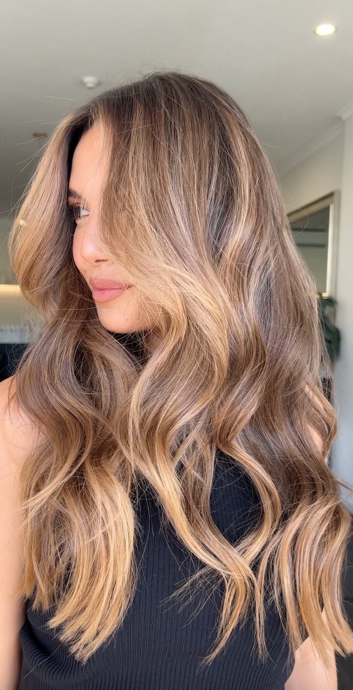 Long wavy hair with soft honey blonde highlights