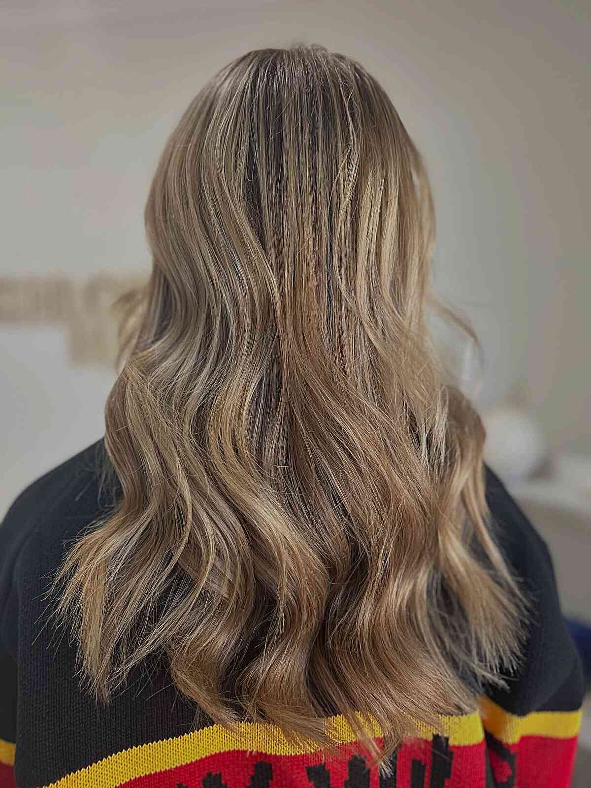 Long wavy hair with honey blonde highlights