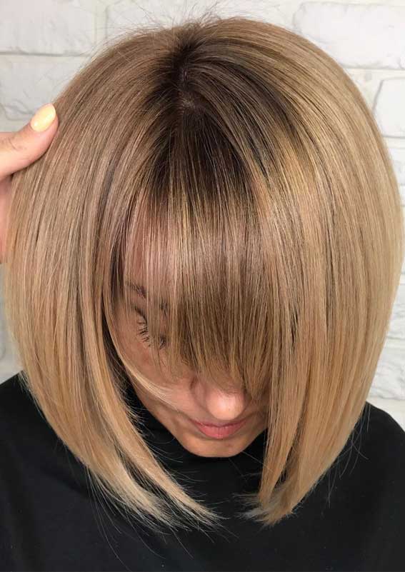 Sleek bob with honey blonde and bangs