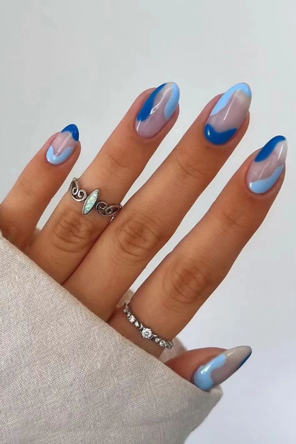 Abstract azure nails with light blue and navy swirls, artistic expression