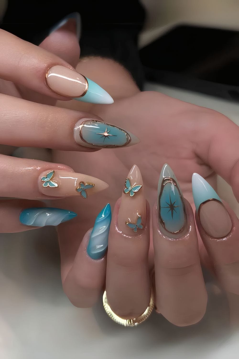 Turquoise nails with celestial accents, starry charm, elegant details