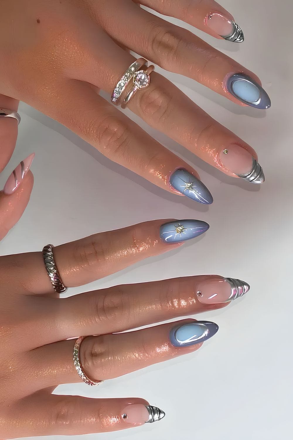 Light blue nails with metallic accents, modern chic style