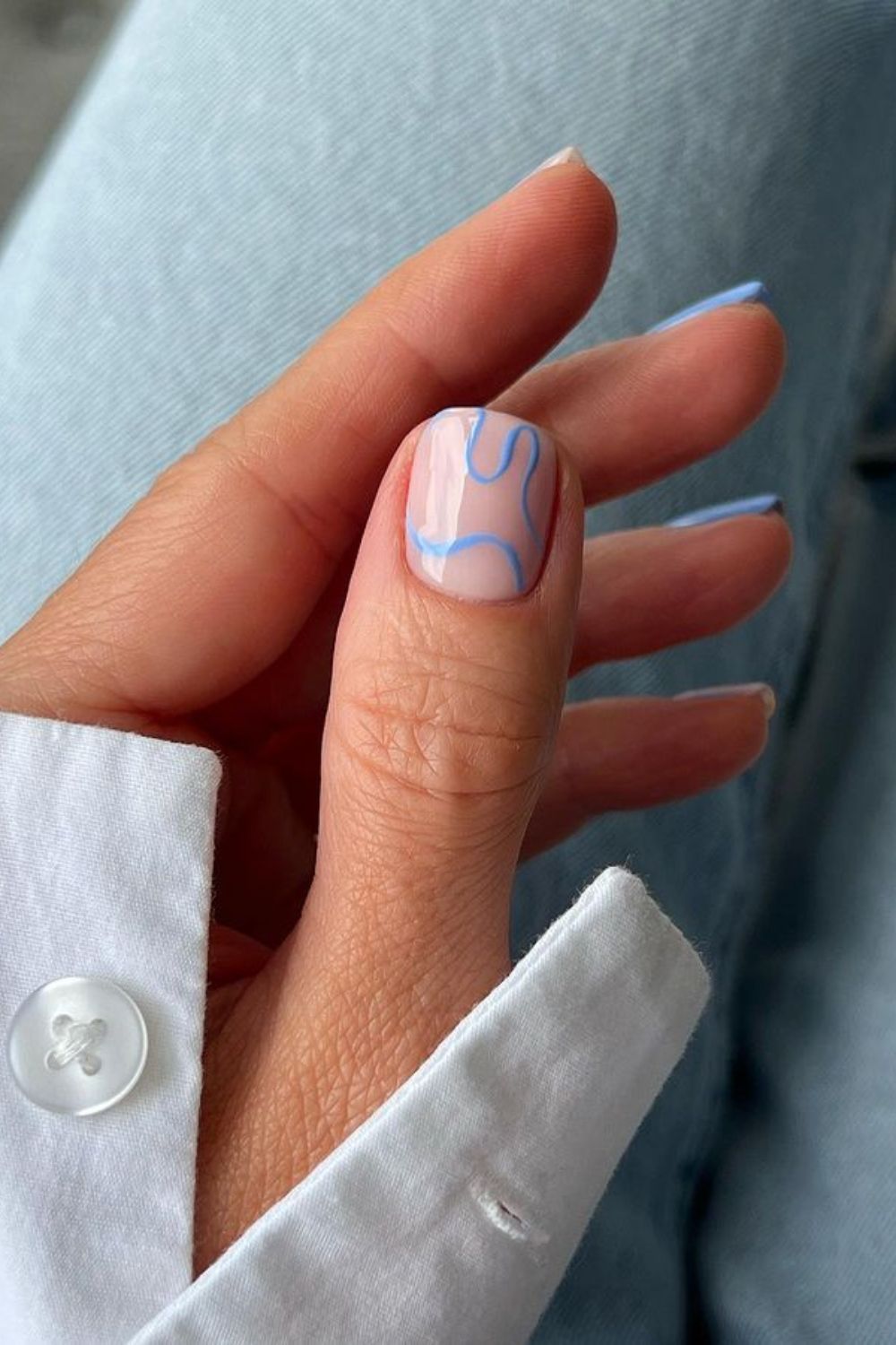 Abstract blue lines on nude nails