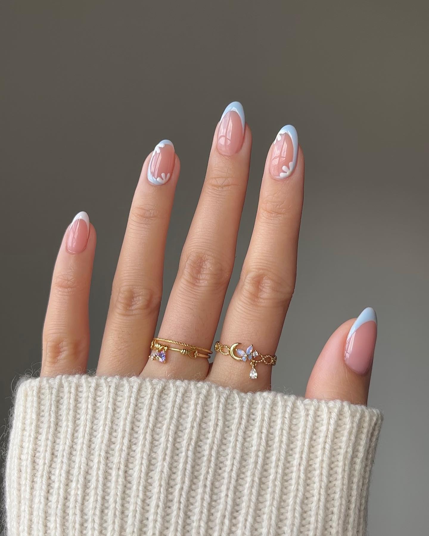 Delicate blue French tips with floral accents