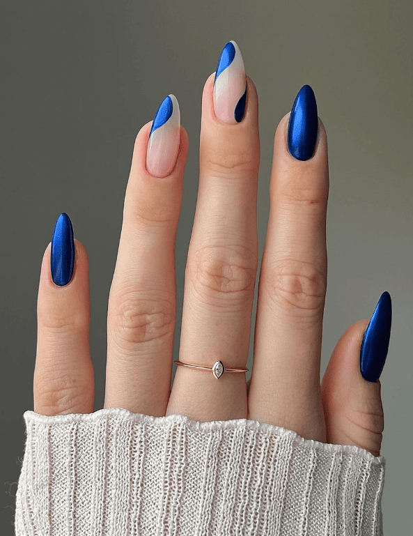 Bold blue and nude contrast on long almond nails