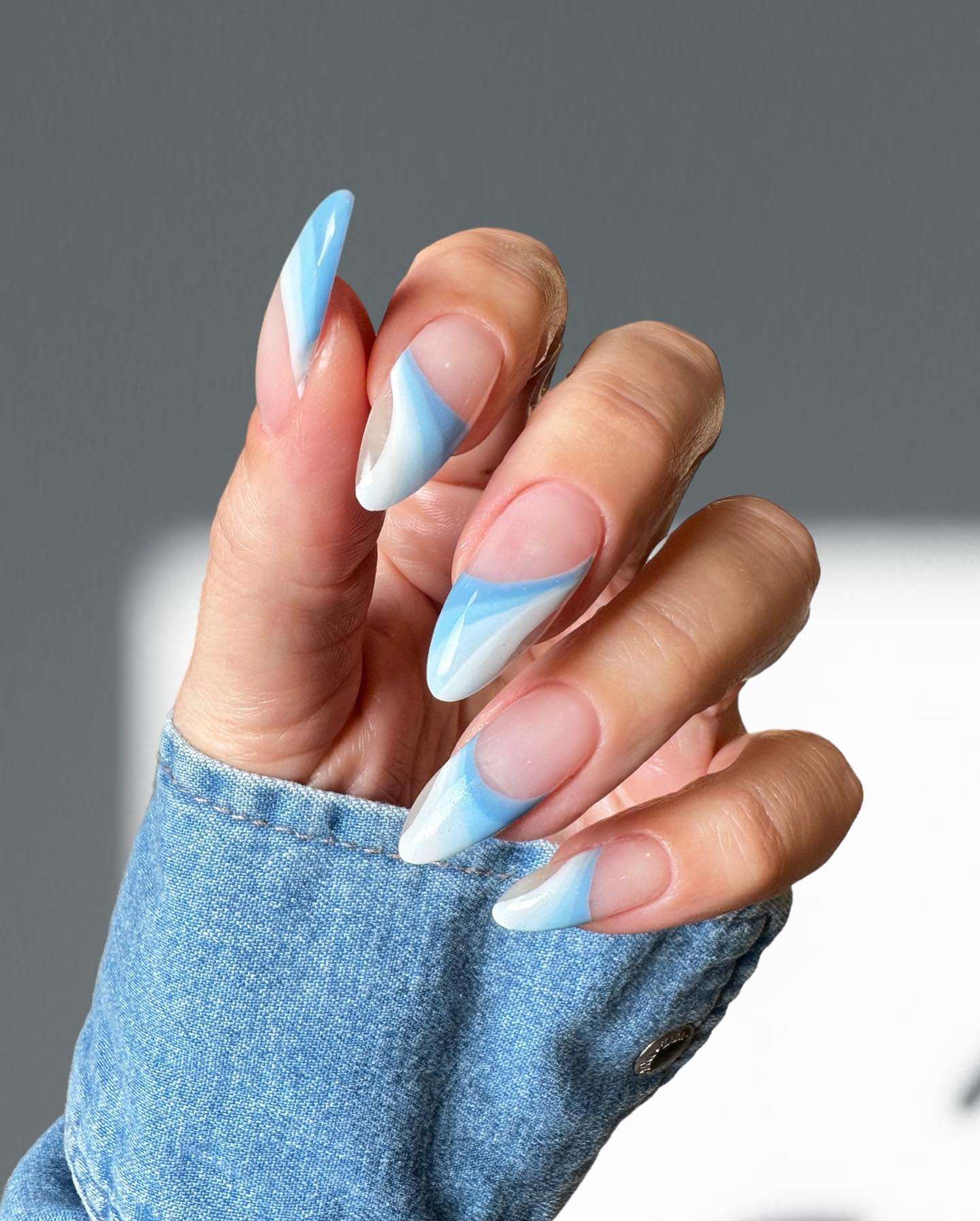 Swirling blue and white on stiletto nails