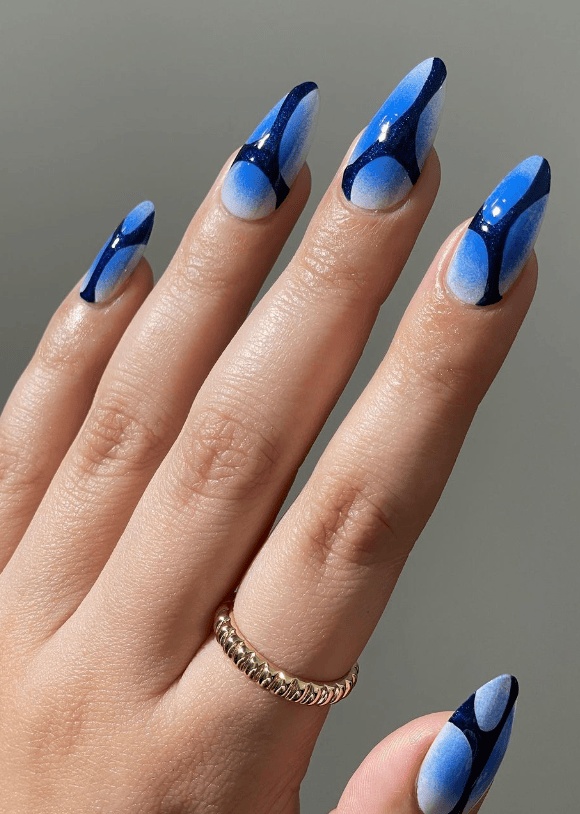 Geometric blue design on almond nails